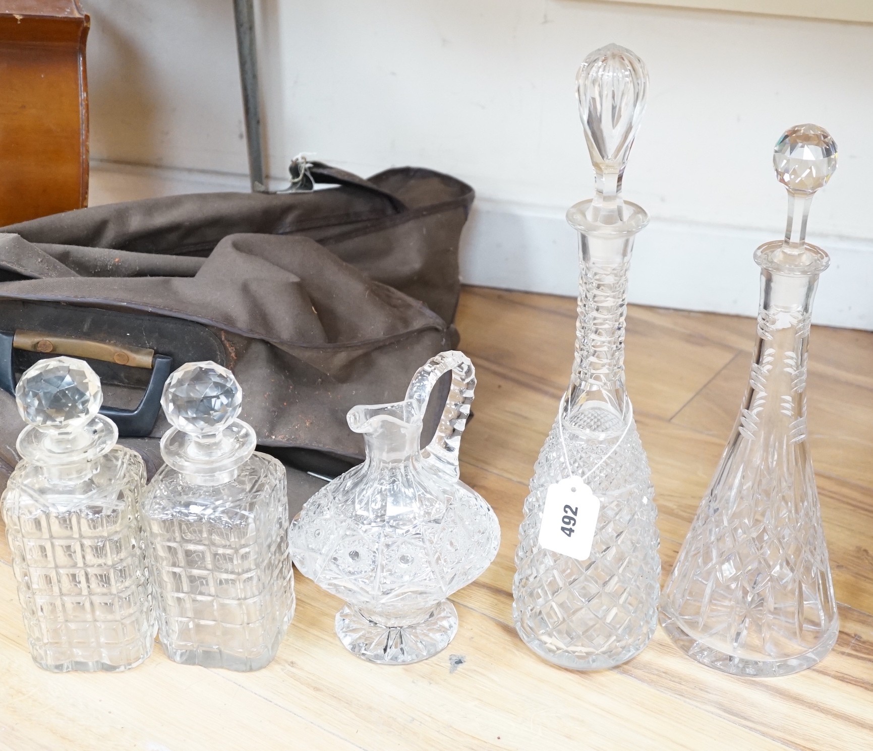 A pair of square cut glass decanters, two other decanters, all with stoppers and a similar jug, tallest decanter 44cms including stopper